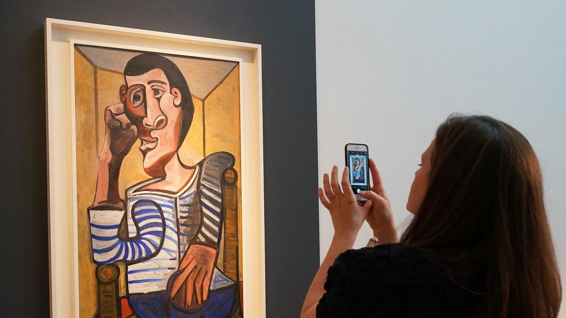 A Christie's employee takes a picture of Pablo Picasso's "Le Marin" during a media preview at Christie's in New York. (AFP)