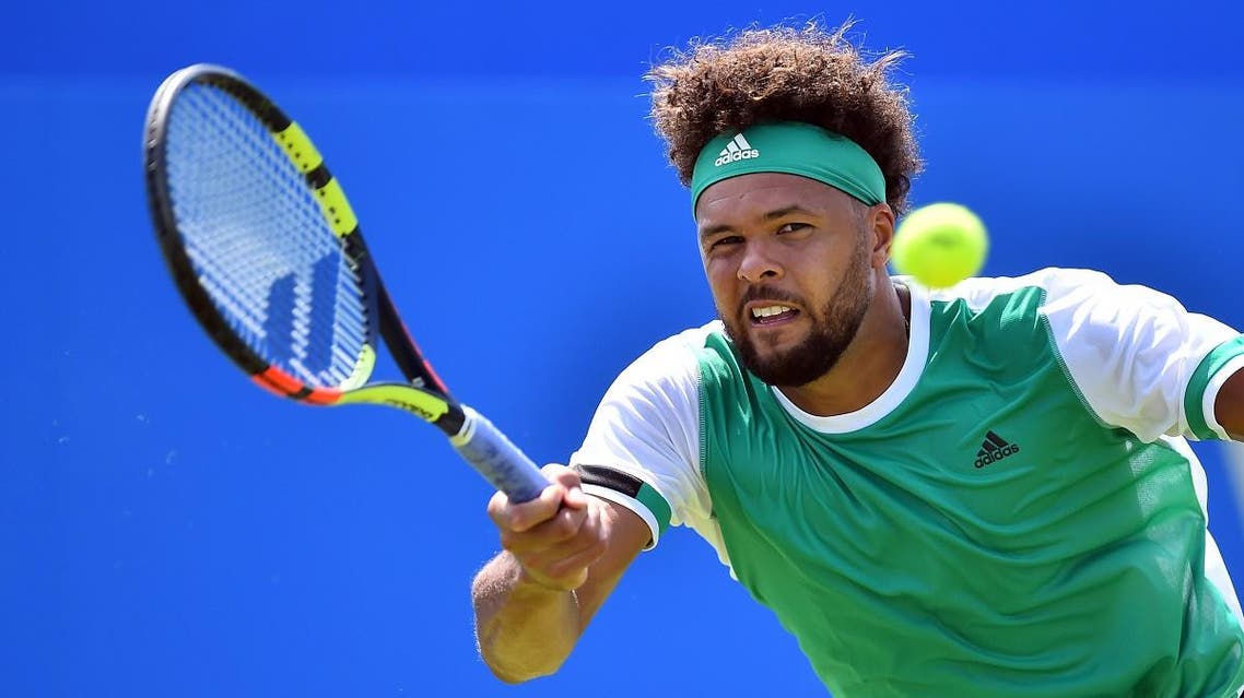 France's Jo-Wilfried Tsonga returns against France's Adrian Mannarino in their men's singles 1st round match at the ATP Aegon Championships tennis tournament at Queen's Club in west London on June 19, 2017. (AFP)