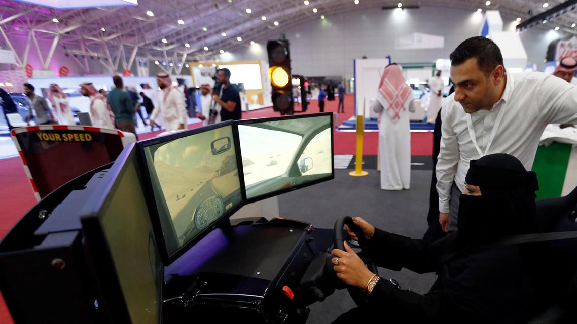 A Saudi woman tries a car simulator during women car show in Riyadh. (Reuters)