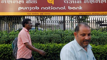 Pedestrians walk past a Punjab National Bank office in Mumbai on February 21, 2018. (Reuters)
