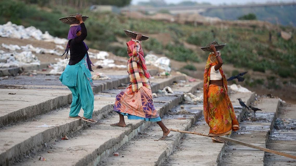 Indian women labours work at a construction site on the eve of the International Labour Day in Allahabad. (AFP)