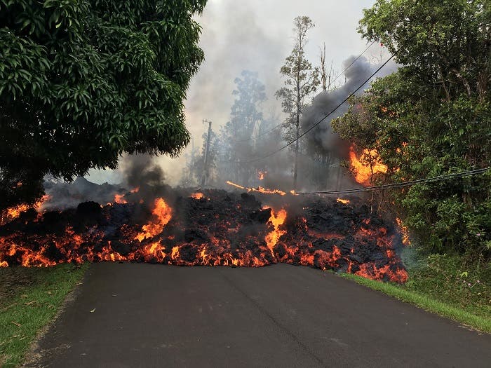 A lava flow from the Kilauea volcano, moves on a street in Leilani Estates in Hawaii, US May 6, 2018. (Reuters)