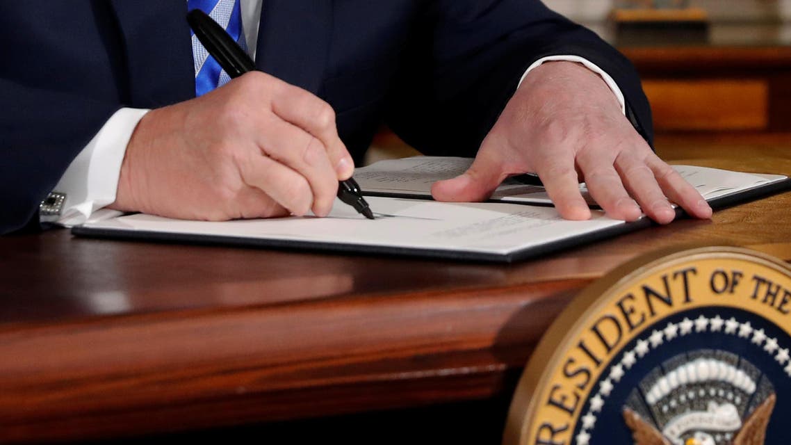 U.S. President Donald Trump signs a proclamation declaring his intention to withdraw from the JCPOA Iran...