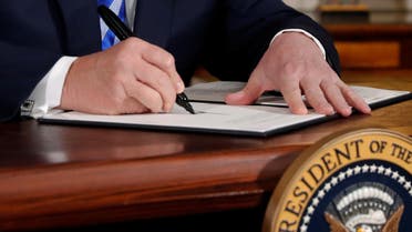 U.S. President Donald Trump signs a proclamation declaring his intention to withdraw from the JCPOA Iran...
