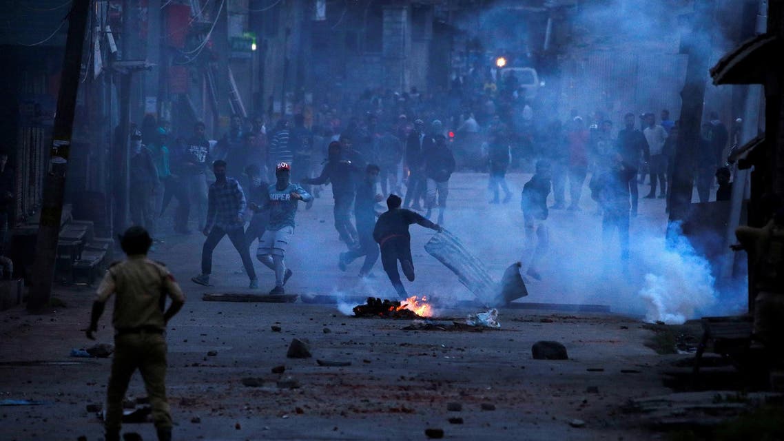 Demonstrators throw stones towards the Indian police during a protest against the recent killings in Kashmir, in Srinagar, on May 8, 2018. (Reuters)