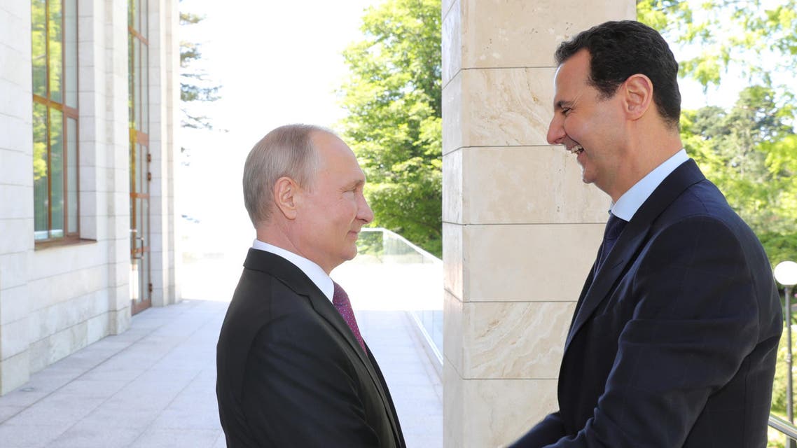 Russian President Vladimir Putin welcomes Syrian President Bashar al-Assad during their meeting in the Black Sea resort of Sochi, Russia May 17, 2018.