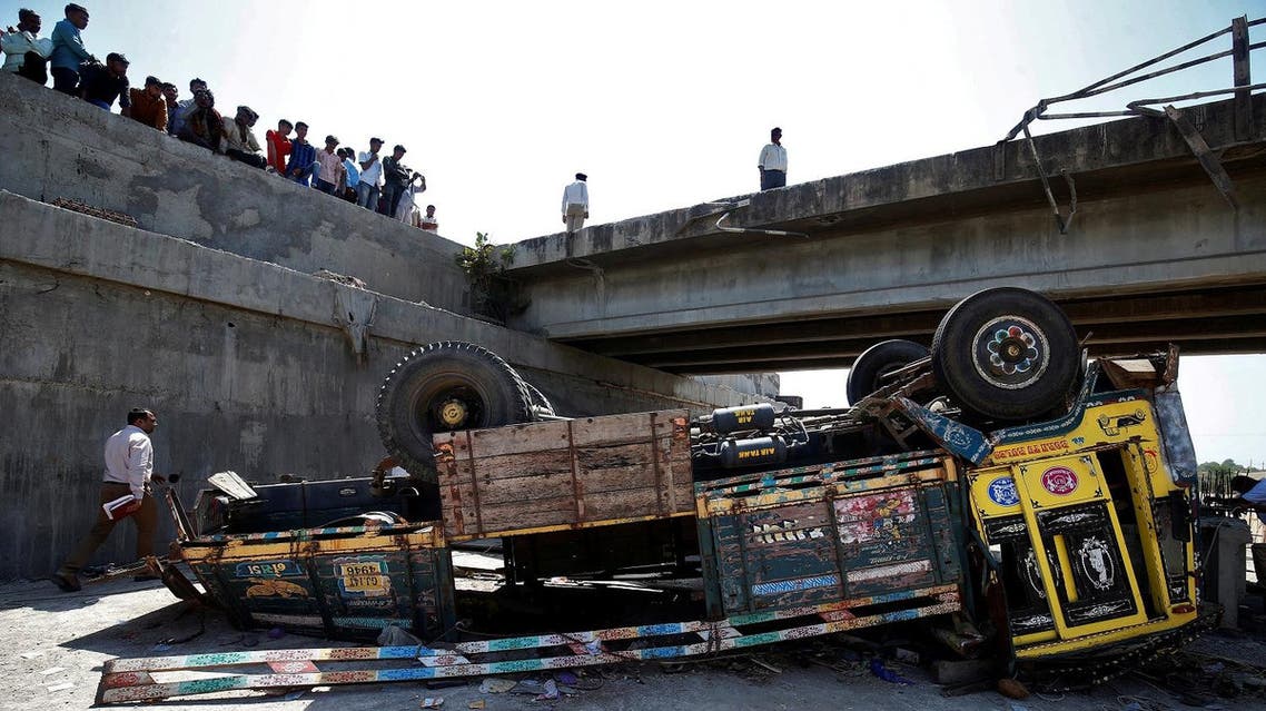 Police officers inspect the site of an accident after a truck carrying wedding party guests plunged into a dry riverbed, in Ranghola village in Bhavnagar district, in the western Indian state of Gujarat, India, on March 6, 2018. (Reuters)