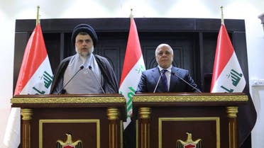 Iraqi Shiite cleric Moqtada al-Sadr speaks during a news conference with Iraqi Prime Minister Haider al-Abadi. (Reuters)