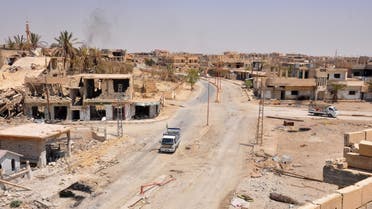 A general view taken on August 13, 2017, shows a vehicle driving down a damaged street in the central Syrian town of Al-Sukhnah, situated in the county's large desert area called the Badiya, as pro-government forces clear the area after taking control of the city from Islamic State (IS) group fighters. Supported by regime ally Russia, Syria's army has waged a months-long offensive to recapture the vast desert region that stretches from the country's centre to the Iraqi and Jordanian borders.