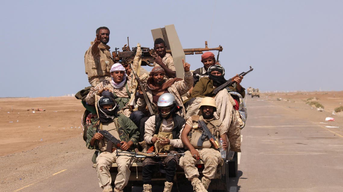 Members of the Yemeni army ride on the back of a military truck near the Red Sea coast city of al-Mokha. (Reuters)