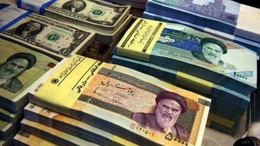 Iranian and US banknotes are on display at a currency exchange shop in downtown Tehran, Iran. (AP)