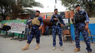 Iraqi security forces stand guard outside a polling station during the parliamentary election in the Sadr city district of Baghdad, Iraq May 12, 2018. REUTERS/Wissm al-Okili