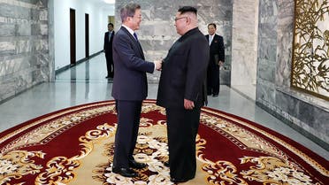 This handout from the Blue House taken and released on May 26, 2018 shows South Korea’s President Moon Jae-in (L) shaking hands with North Korea's leader Kim Jong Un before their second summit at the north side of the truce village of Panmunjom in the Demilitarized Zone (DMZ). (AFP)