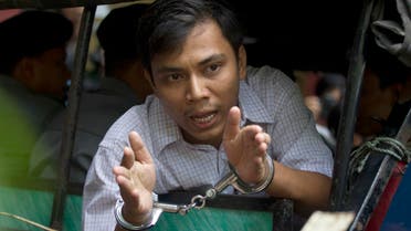 Reuters journalist Kyaw Soe Oo speaks from a police truck as he leaves a court after his trial on May 2, 2018, Yangon, Myanmar. (AP)