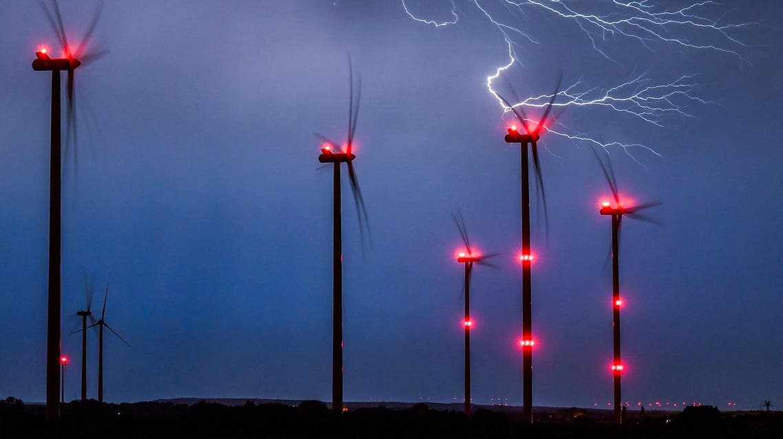 Lightning strikes close to wind turbines in a wind energy park during a thunderstorm near Sieversdorf, eastern Germany, on August 28, 2016. (AFP)