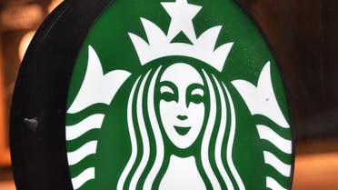 The sign for a Starbucks Coffee shop is seen in New York on April 17, 2018, following the company's announcement that they will close more than 8,000 US stores on May 29 to conduct "racial-bias education" following the arrest of two black men in one of its cafes. 