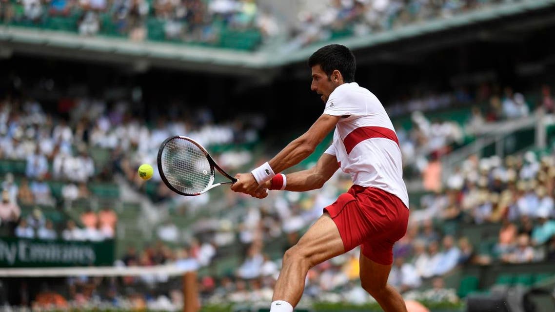 Serbia's Novak Djokovic plays a return to Brazil's Rogerio Dutra Silva during their men's singles first round match on day two of The Roland Garros 2018 French Open tennis tournament in Paris on May 28, 2018. CHRISTOPHE SIMON / AFP