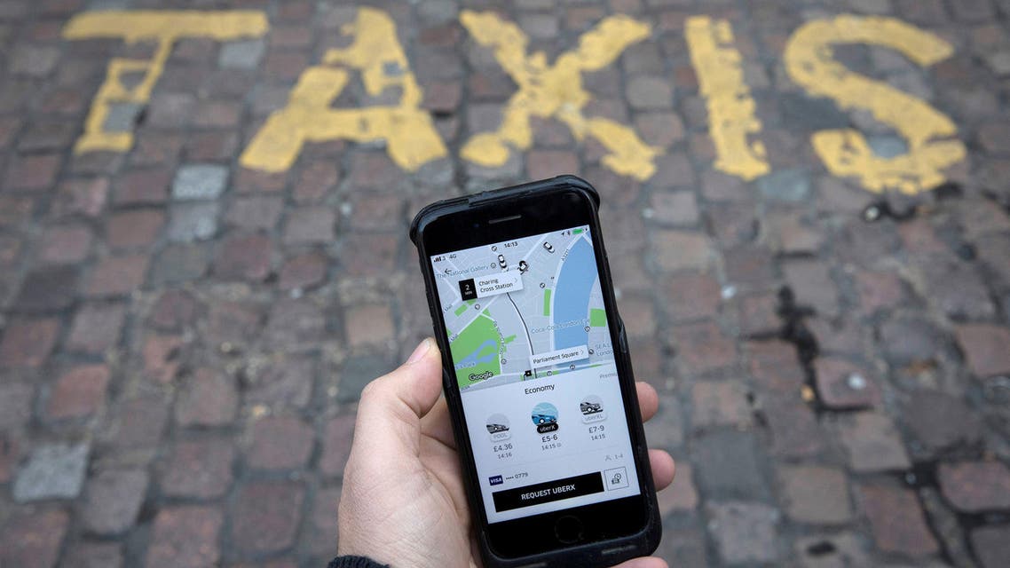 A photo illustration shows the Uber app on a mobile telephone, as it is held up for a posed photograph, in London on November 10, 2017. (Reuters)