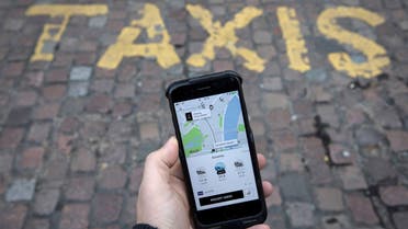 A photo illustration shows the Uber app on a mobile telephone, as it is held up for a posed photograph, in London on November 10, 2017. (Reuters)