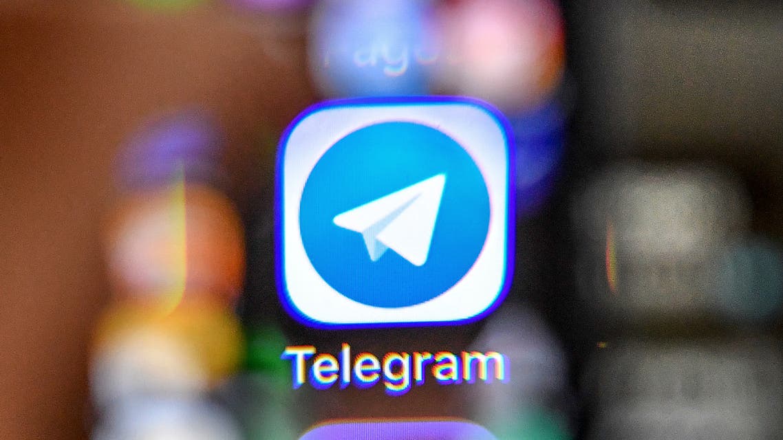 An illustration picture taken through a magnifying glass on April 17, 2018 in Moscow shows the icon of the popular messaging app Telegram on a smart phone screen. Russia's communications watchdog began today blocking access to the popular messaging app Telegram after a court banned the service for refusing to give the security services access to private conversations.