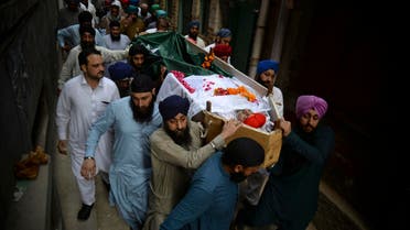 People carry the body of Charanjit Singh during his funeral in Peshawar on May 30, 2018. (AP)