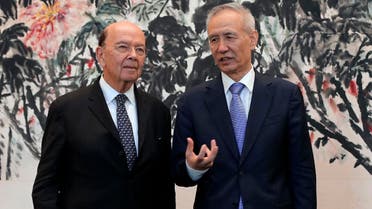 US Commerce Secretary Wilbur Ross (L) chats with Chinese Vice Premier Liu He during a photograph session after their meeting at the Diaoyutai State Guesthouse in Beijing on June 3, 2018. (AFP)