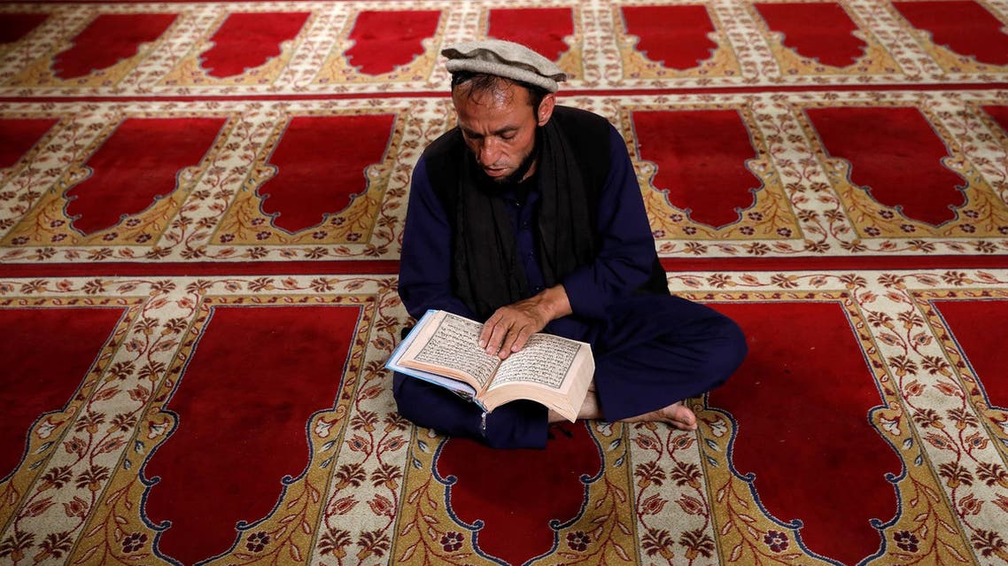 An Afghan man reads the Koran at a mosque on the first day of the holy month of Ramadan in Kabul, Afghanistan. (Reuters)