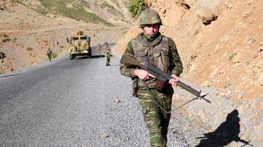 Turkish soldiers patrol a road near Cukurca in the Hakkari province, southeastern Turkey, near the Turkish-Iraqi border October 22, 2011. Turkish troops killed 32 Kurdish militants in clashes in Cukurca Kazan valley, in Hakkari province in southeast Turkey, state-run television TRT reported on Saturday, in the third day of an offensive to avenge the deaths of 24 soldiers this week. Turkey's leaders have vowed revenge after one of the worst losses of life suffered by the army since the separatist insurgency began in 1984, when PKK guerrillas mounted a series of deadly night-time raids on army outposts in Turkey's mountainous southeast on Wednesday. REUTERS/Stringer (TURKEY - Tags: POLITICS MILITARY)
