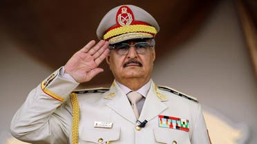 Libyan Strongman Khalifa Haftar salutes during a military parade in the eastern city of Benghazi on May 7, 2018, during which he announced a military offensive to take from "terrorists" the city of Derna, the only part of eastern Libya outside his forces' control.  Abdullah DOMA / AFP