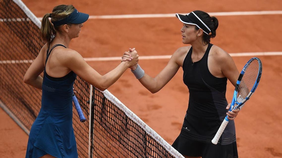 Spain's Garbine Muguruza (R) is congratulated by Russia's Maria Sharapova after winning. (AFP)