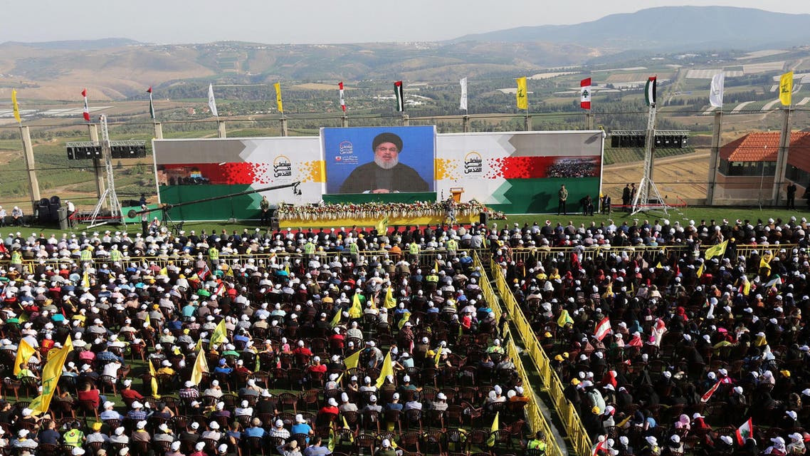 Hassan Nasrallah addresses his supporters via a screen during a rally near the border with Israel on June 8, 2018. (Reuters)