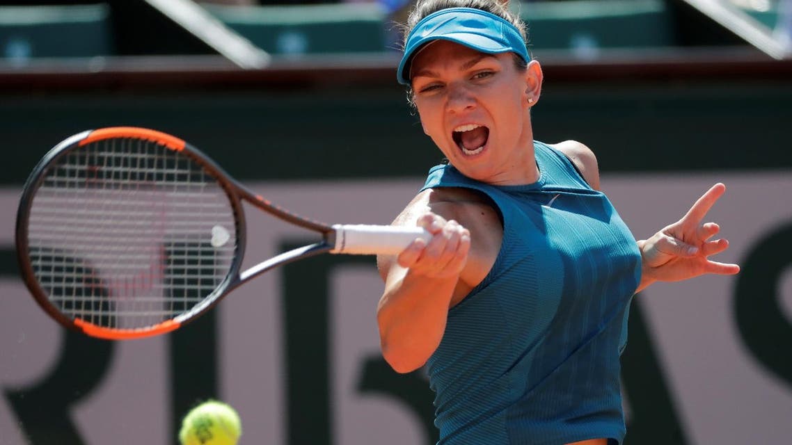Simona Halep plays a forehand return to Garbine Muguruza during their women’s singles semi-final match at French Open in Paris on June 7, 2018. (AFP)