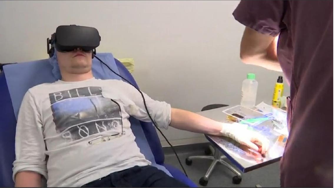 Emergency room patient at Saint-Joseph Hospital wearing Virtual Reality (VR) helmet. (Screen grab from Reuters)