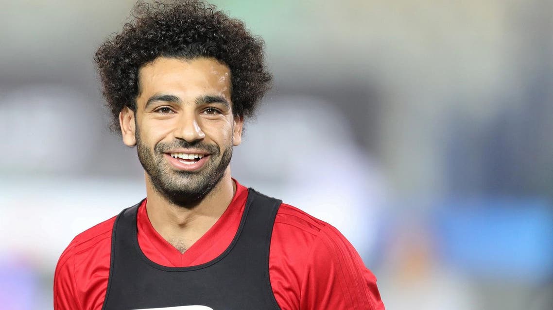 Mohamed Salah smiles next to his teammates in Cairo international stadium. (Reuters)