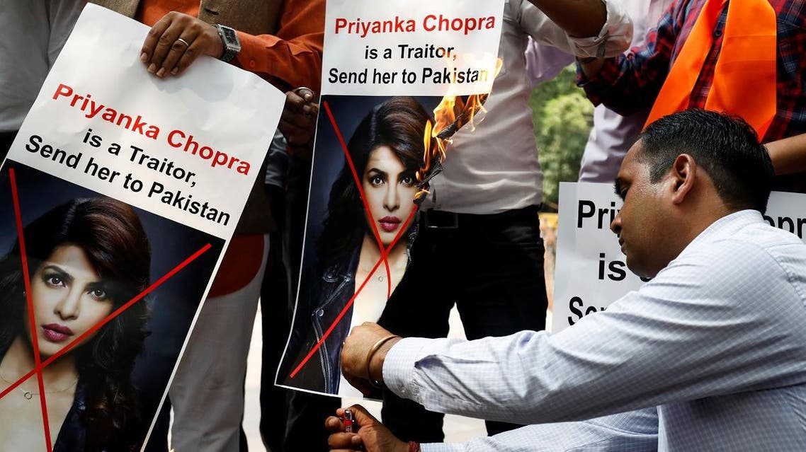 Supporters of Hindu Sena, a right wing Hindu group, burn posters of Bollywood actress Priyanka Chopra during a protest, in New Delhi. (Reuters)
