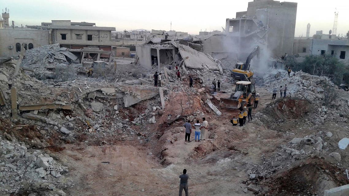 This photo provided by the Syrian Civil Defense White Helmets, which has been authenticated based on its contents and other AP reporting, shows civil defense workers and civilians inspecting damaged buildings after airstrikes hit in the village of Zardana, in Idlib province, Syria, Friday, June 8, 2018. (AP)