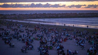Moroccans break Ramadan fast on beach with song, dance, food