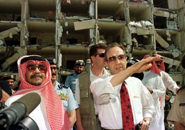 US Secretary of Defence William Perry (R), accompanied by the Saudi Ambassador to the US, Prince Bandar bin Sultan bin Abd al-Aziz Al Saud (L), survey the bomb site outside the heavily damaged apartment at the Khobar Towers housing complex in Dhahran June 29. (Reuters)