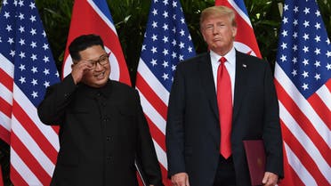 North Korea's leader Kim Jong Un (L) poses with US President Donald Trump (R) after taking part in a signing ceremony at the end of their historic US-North Korea summit, at the Capella Hotel on Sentosa island in Singapore on June 12, 2018. Donald Trump and Kim Jong Un became on June 12 the first sitting US and North Korean leaders to meet, shake hands and negotiate to end a decades-old nuclear stand-off. (AFP)
