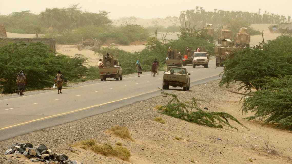 Yemeni pro-government forces stand next to a pickup truck carrying anti-aircraft guns along they way to al-Durayhimi district, about nine kilometres south of Hodeidah international airport on June 13, 2018. Yemeni forces backed by the Saudi-led coalition launched an offensive on June 13 to retake the rebel-held Red Sea port city of Hodeida, pressing toward the airport south of the الحديدة city. الحددال