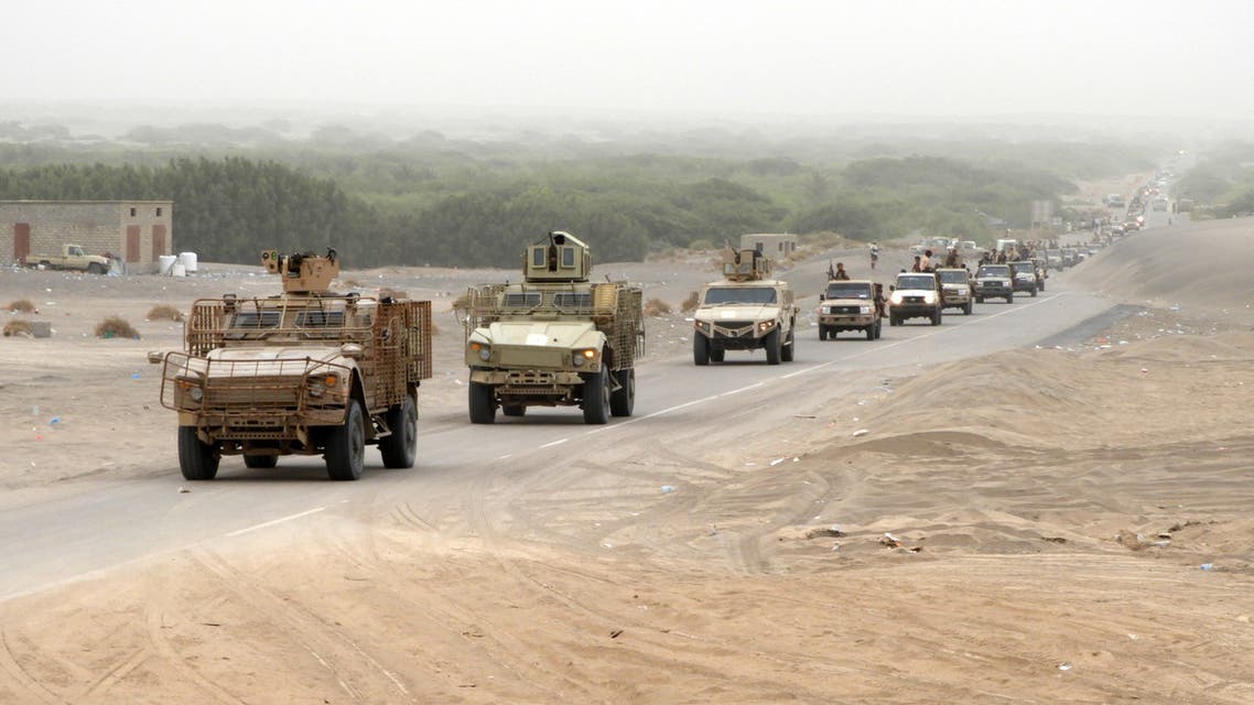 Yemeni pro-government forces stand next to a pickup truck carrying anti-aircraft guns along they way to al-Durayhimi district, about nine kilometres south of Hodeidah international airport on June 13, 2018. Yemeni forces backed by the Saudi-led coalition launched an offensive on June 13 to retake the rebel-held Red Sea port city of Hodeida, pressing toward the airport south of the الحديدة city. الحددال