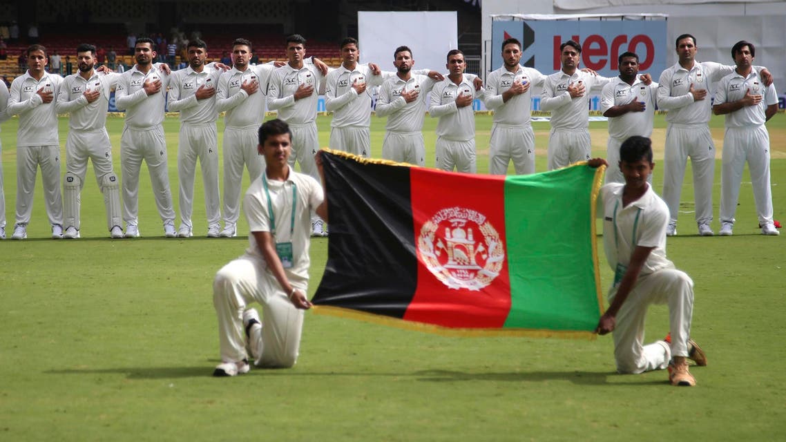 Members of Afghanistan cricket team stand for their national anthem before the start of the one-off test match against India in Bangalore on June 14, 2018. (AP)