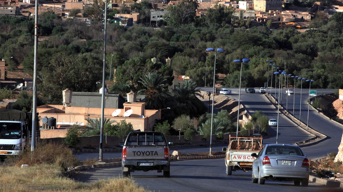 Vehicles drives along a highway leading into the Libyan city of Bani Walid, 15 days after the end of a military operation, on November 10, 2012. Hundreds of Libyan families and foreign workers fled the city last month, one of the last bastions of Moamer Kadhafi's regime and scene of deadly clashes between pro-government forces and fighters described by authorities as criminals and loyalists of Kadhafi's ousted regime. AFP/PHOTO/MAHMUD TURKIA