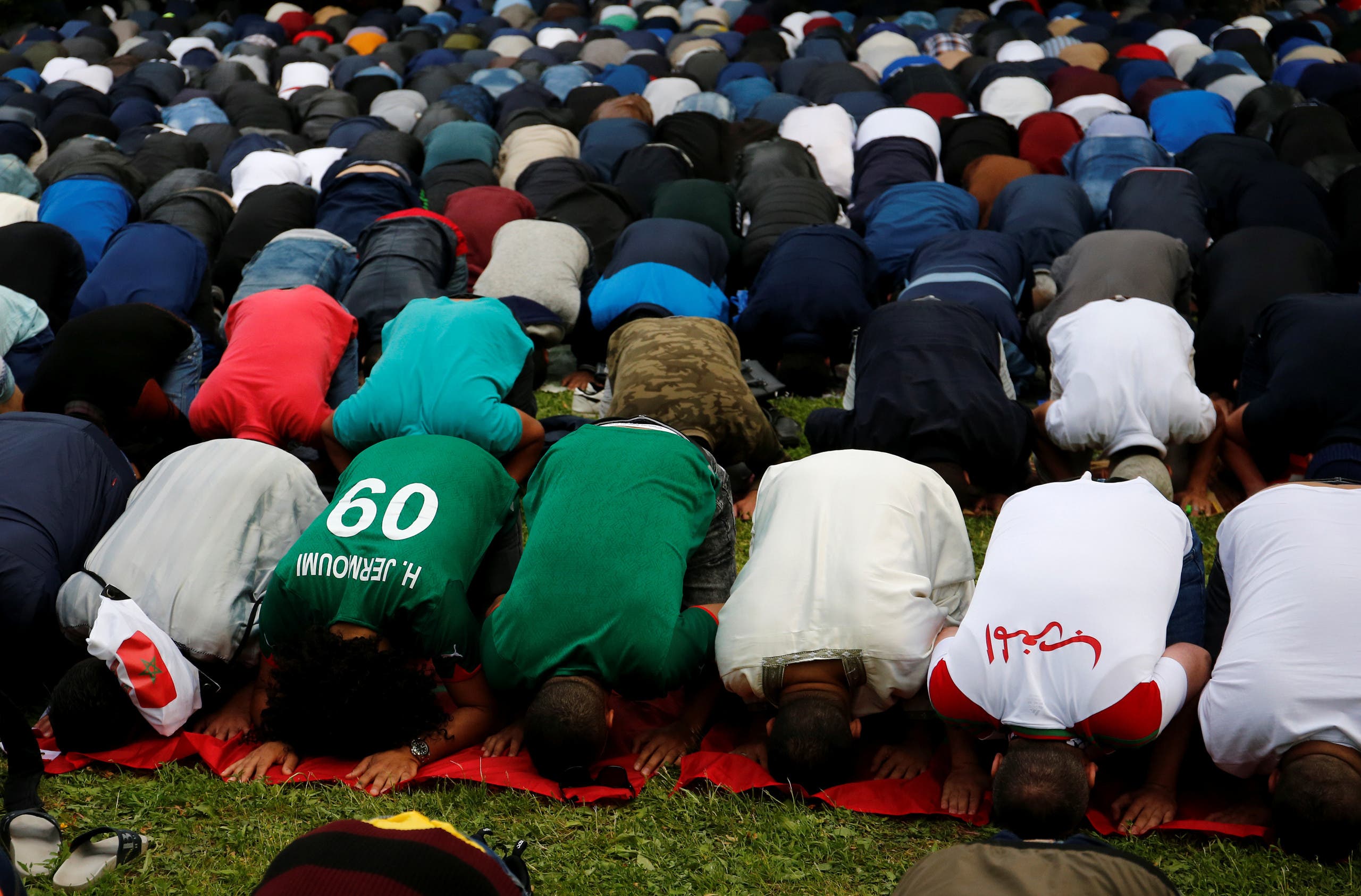 Muslims, including supporters of national soccer teams, attend an Eid al-Fitr mass prayer. (Reuters)
