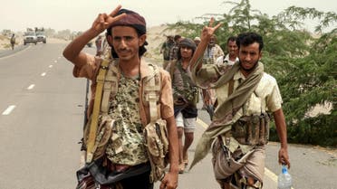 Yemeni pro-government forces flash the victory gesture as they arrive in al-Durayhimi district, about nine kilometres south of Hodeidah international airport on June 13, 2018. (AFP)