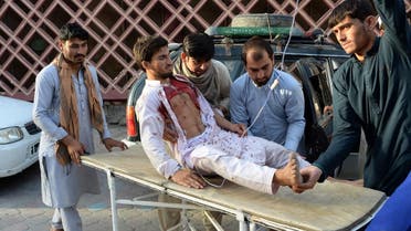Afghan volunteers carry an injured man on a stretcher to an hospital following a suicide bomber blew himself in Jalalabad. (AFP)