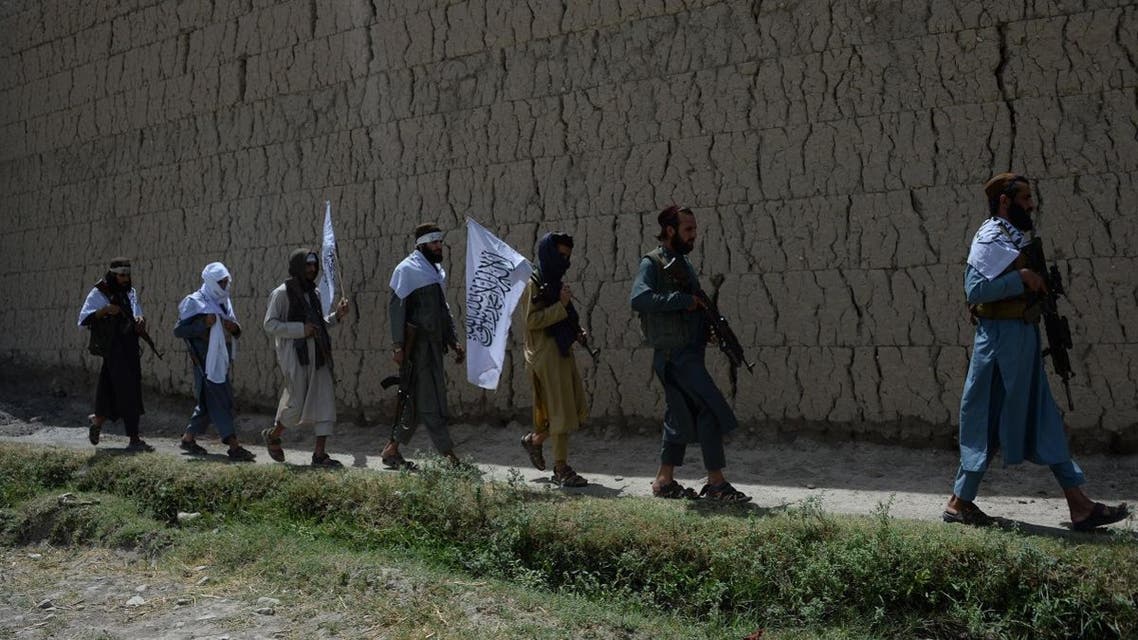 Afghan Taliban militants walk as they took to the street to celebrate ceasefire on the second day of Eid in the outskirts of Jalalabad on June 16, 2018. (AFP)