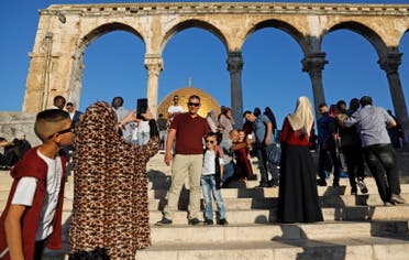 Palestinian Muslim worshippers take pictures as they gather for the morning Eid al-Fitr prayer near the Dome of Rock at the Al-Aqsa Mosque compound, Islam's third most holy site, in the Old City of Jerusalem on June 15, 2018. (AFP)