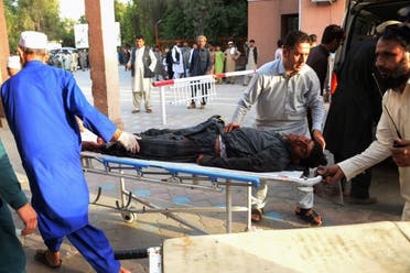 Afghan volunteers carry an injured man on a stretcher to an hospital following a suicide bomber blew himself in Jalalabad on June 16, 2018. (Reuters)