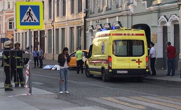An ambulance is parked near a damaged taxi, which ran into crowds of people in central Moscow. (Reuters)